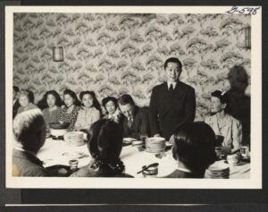 Minoru Yamasaki speaking at a dinner at the Miyako Restaurant in honor of Harold Fistere, Relocation Supervisor for the Middle Atlantic Area. Those attending included representatives from the following organizations: Committee on Resettlement of Japanese Americans of the Federal Council of Churches of Christ in America, Japanese American Resettlement Committee of the Brooklyn Council for Social Planning, Arts Council of Japanese Americans for Democracy, Japanese American Committee for Democracy, New York Japanese American Hostel, Resettlement Council of Japanese American organizations in N.Y.C., Japanese American church, Young People's Society of the Japanese Methodist Church, Japanese Christian Association, New York Church Committee for Japanese Americans, Japanese Buddhist Church, Young People's Circle of the Japanese Christian Institute, Japanese American Young People's Christian Federation, Junior Japanese Christian Association Brooklyn Church and Mission Federation, New York, New York.